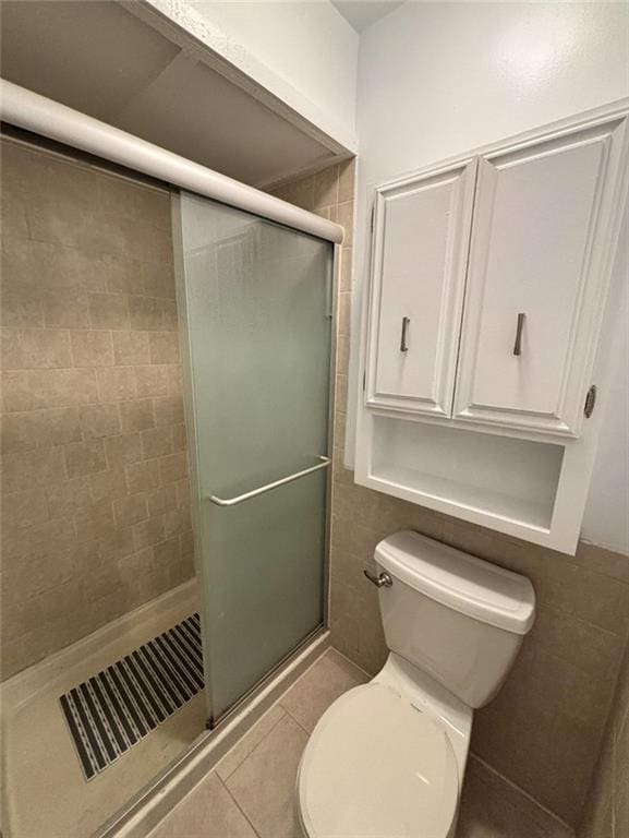 1702 Countryside Dr, Pittsburg, KS 66762 - bathroom featuring tile patterned flooring, a shower stall, and toilet