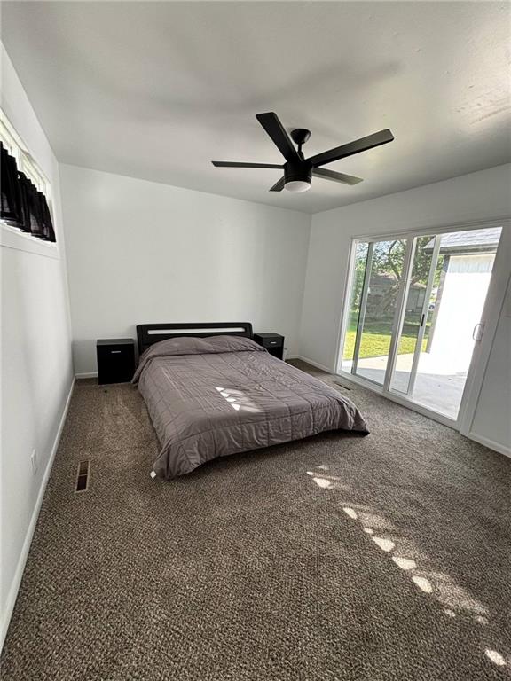 1702 Countryside Dr, Pittsburg, KS 66762 - bedroom with access to outside, carpet, baseboards, and a ceiling fan