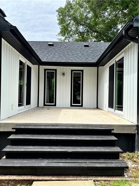 1702 Countryside Dr, Pittsburg, KS 66762 - entrance to property featuring roof with shingles and a wooden deck