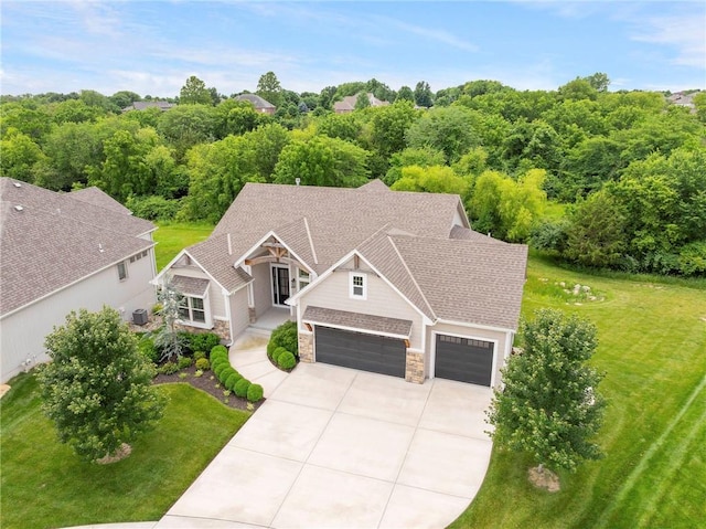 20611 W 113th St, Olathe, KS 66061 - view of front of property with stone siding, driveway, and a front lawn