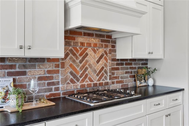 20611 W 113th St, Olathe, KS 66061 - kitchen featuring stainless steel gas stovetop, custom exhaust hood, white cabinets, tasteful backsplash, and dark countertops