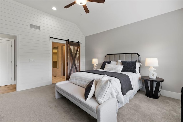 20611 W 113th St, Olathe, KS 66061 - bedroom with a barn door, vaulted ceiling, light carpet, wooden walls, and a ceiling fan