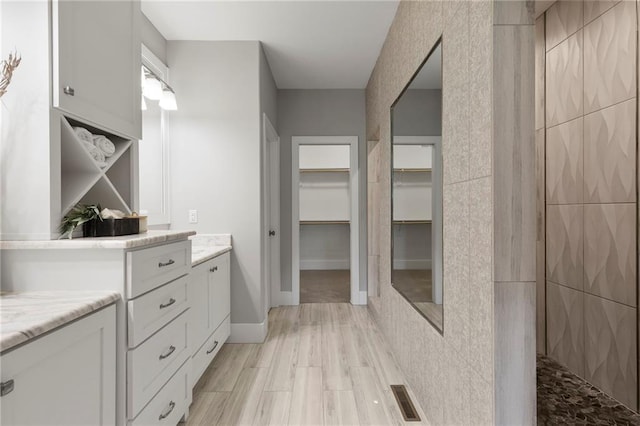 20611 W 113th St, Olathe, KS 66061 - full bathroom with vanity, a spacious closet, and a tile shower
