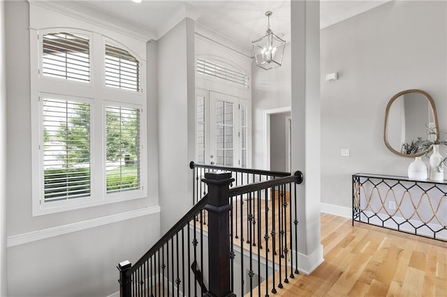 20611 W 113th St, Olathe, KS 66061 - corridor with an upstairs landing, a chandelier, wood finished floors, and ornamental molding