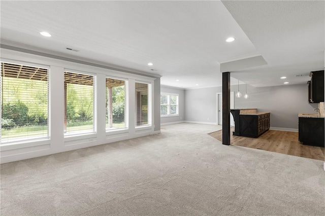 20611 W 113th St, Olathe, KS 66061 - unfurnished living room featuring light colored carpet and recessed lighting