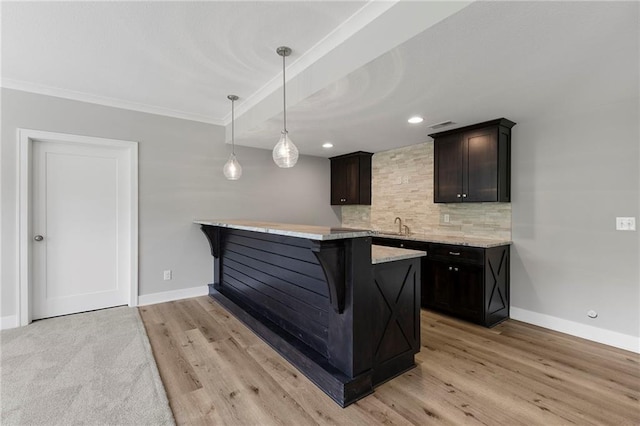 20611 W 113th St, Olathe, KS 66061 - kitchen featuring decorative backsplash, a breakfast bar area, light wood finished floors, a peninsula, and ornamental molding