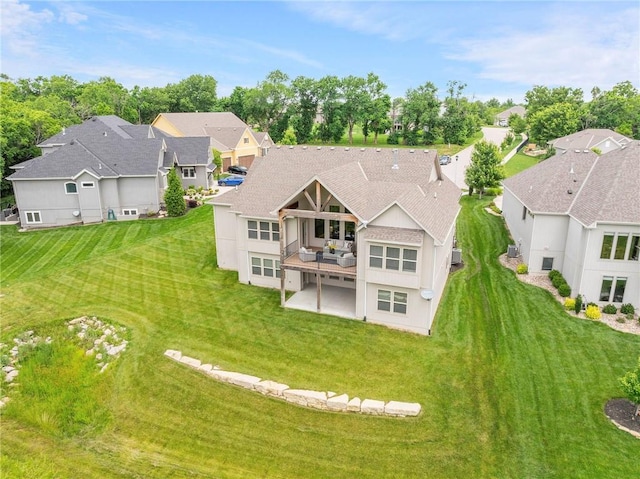 20611 W 113th St, Olathe, KS 66061 - back of house featuring a residential view, a patio, a lawn, a balcony, and roof with shingles