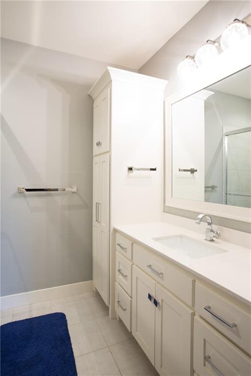 10702 W 142nd Ter, Overland Park, KS 66221 - full bathroom with vanity, a shower with shower door, tile patterned flooring, and baseboards