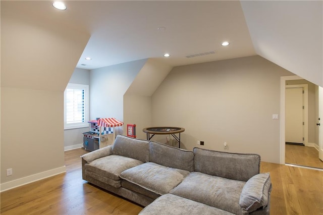 10702 W 142nd Ter, Overland Park, KS 66221 - living area with lofted ceiling, light wood finished floors, recessed lighting, and baseboards