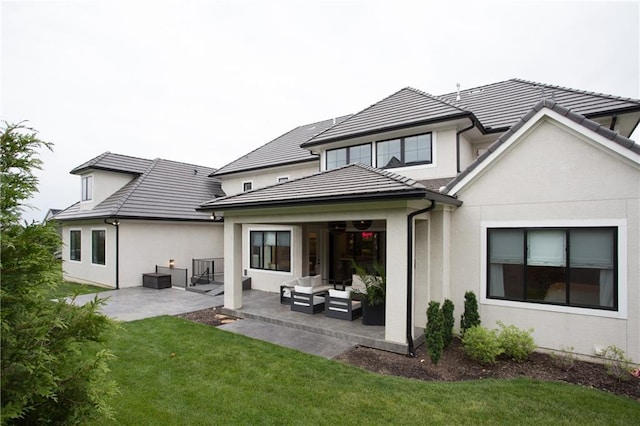 10702 W 142nd Ter, Overland Park, KS 66221 - rear view of house featuring an outdoor hangout area, a patio area, stucco siding, a yard, and a tiled roof