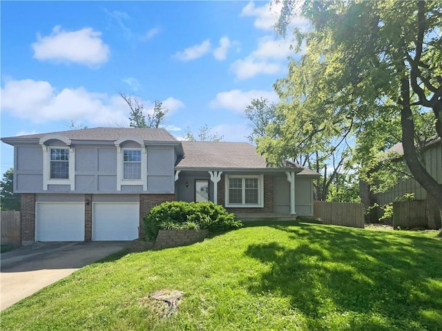 2157 E 154th St, Olathe, KS 66062 - tri-level home with brick siding, a garage, and driveway