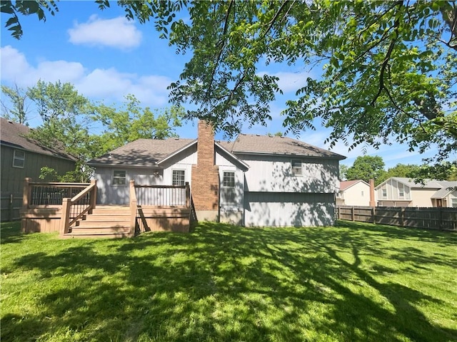 2157 E 154th St, Olathe, KS 66062 - back of property with a wooden deck and a chimney