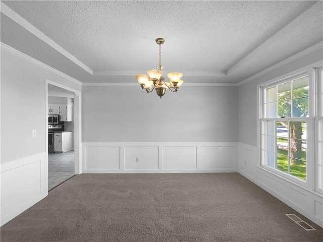 2157 E 154th St, Olathe, KS 66062 - empty room with a tray ceiling, a chandelier, crown molding, carpet floors, and a textured ceiling