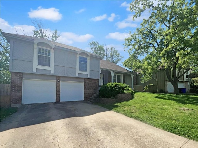 2157 E 154th St, Olathe, KS 66062 - split level home with brick siding, a front yard, an attached garage, and concrete driveway