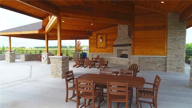 15349 W 173rd Ter, Olathe, KS 66062 - view of patio featuring an outdoor stone fireplace, a gazebo, and outdoor dining space