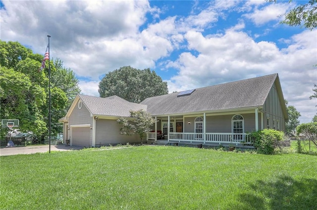 1875 E Mechanic Ave, Independence, MO 64050 - ranch-style home with covered porch, a front lawn, a garage, concrete driveway, and a shingled roof