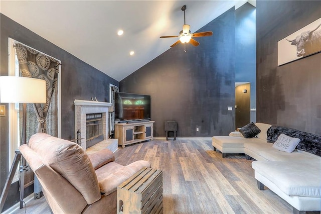 1875 E Mechanic Ave, Independence, MO 64050 - living area with high vaulted ceiling, wood finished floors, ceiling fan, a fireplace, and recessed lighting