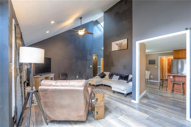 1875 E Mechanic Ave, Independence, MO 64050 - living area with high vaulted ceiling, a ceiling fan, light wood-style flooring, and recessed lighting