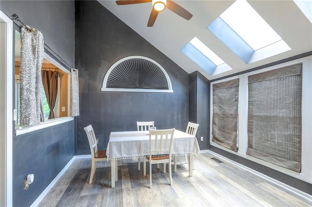 1875 E Mechanic Ave, Independence, MO 64050 - dining room with wood finished floors, a skylight, lofted ceiling, and ceiling fan