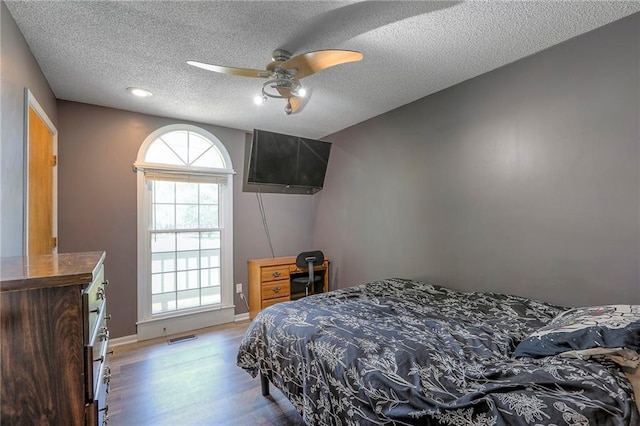 1875 E Mechanic Ave, Independence, MO 64050 - bedroom with light wood-style floors, a textured ceiling, and a ceiling fan