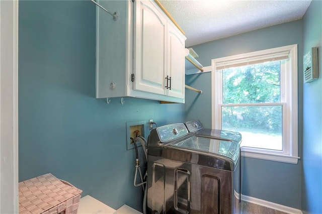 1875 E Mechanic Ave, Independence, MO 64050 - laundry area with cabinet space, washing machine and clothes dryer, and a textured ceiling