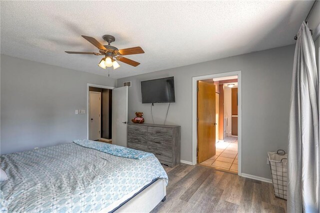 1875 E Mechanic Ave, Independence, MO 64050 - bedroom with wood finished floors, ceiling fan, and a textured ceiling