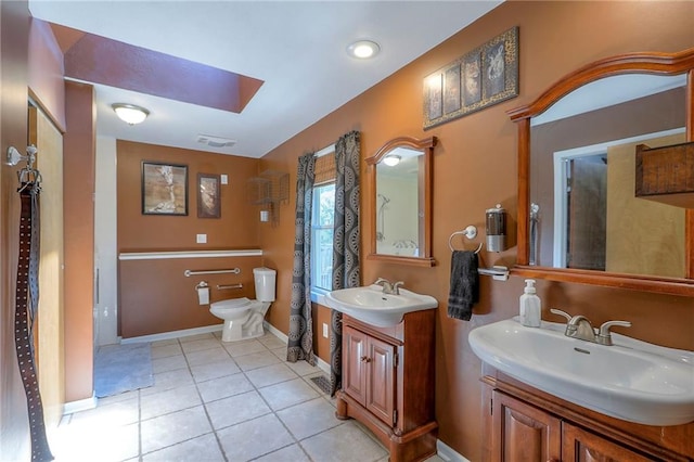 1875 E Mechanic Ave, Independence, MO 64050 - full bath featuring a skylight, tile patterned flooring, and two vanities