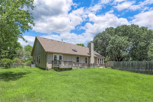 1875 E Mechanic Ave, Independence, MO 64050 - rear view of house with a chimney, a wooden deck, a fenced backyard, and board and batten siding