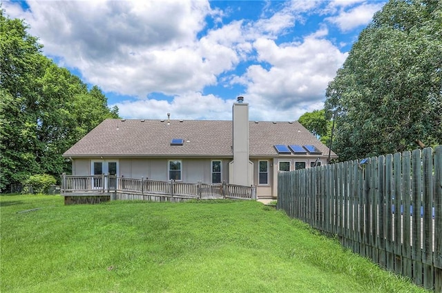 1875 E Mechanic Ave, Independence, MO 64050 - rear view of house featuring a chimney, a deck, roof with shingles, and stucco siding