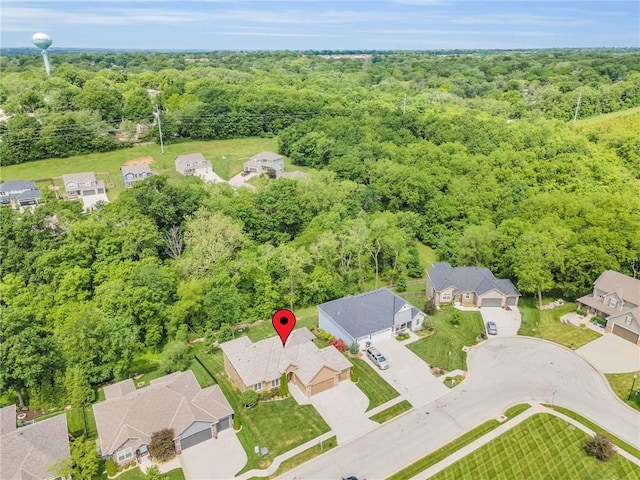 2409 SE Ridge Line Dr, Blue Springs, MO 64014 - aerial perspective of suburban area featuring a heavily wooded area