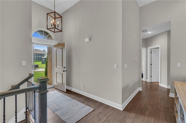 2409 SE Ridge Line Dr, Blue Springs, MO 64014 - entrance foyer with a towering ceiling, a chandelier, dark wood finished floors, and baseboards