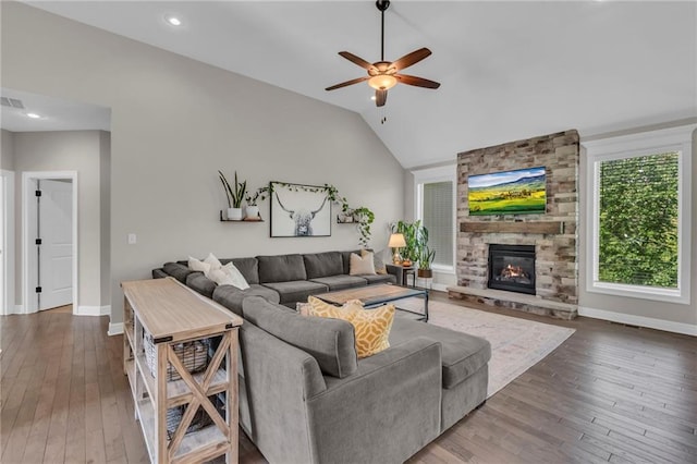 2409 SE Ridge Line Dr, Blue Springs, MO 64014 - living area with ceiling fan, baseboards, hardwood / wood-style flooring, lofted ceiling, and a stone fireplace