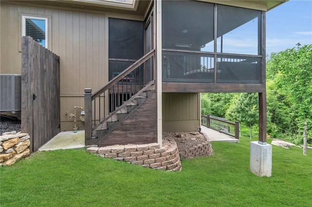 2409 SE Ridge Line Dr, Blue Springs, MO 64014 - view of side of property with a sunroom, cooling unit, stairs, and a lawn