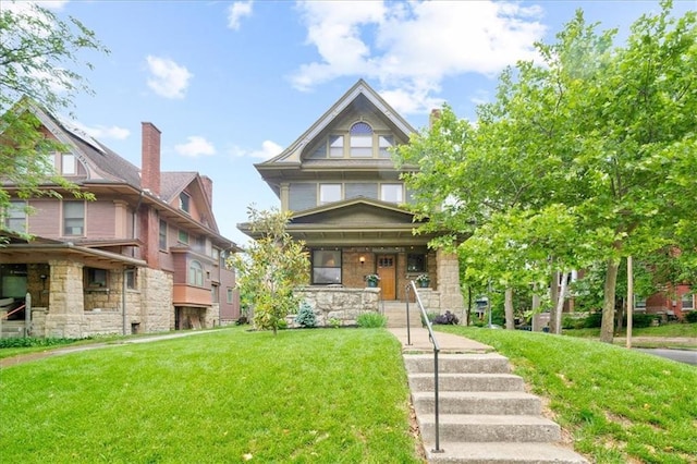 4100 Harrison St, Kansas City, MO 64110 - view of front of house with a front yard, a porch, and stone siding