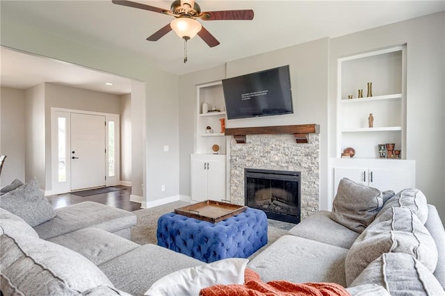 12435 Parkview Ave, Kansas City, KS 66109 - living area featuring baseboards, ceiling fan, built in shelves, and a fireplace