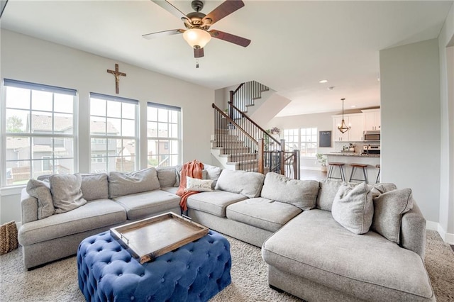 12435 Parkview Ave, Kansas City, KS 66109 - living room with ceiling fan, stairway, light carpet, baseboards, and recessed lighting