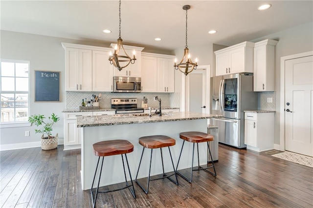 12435 Parkview Ave, Kansas City, KS 66109 - kitchen featuring appliances with stainless steel finishes, a chandelier, white cabinets, a sink, and recessed lighting