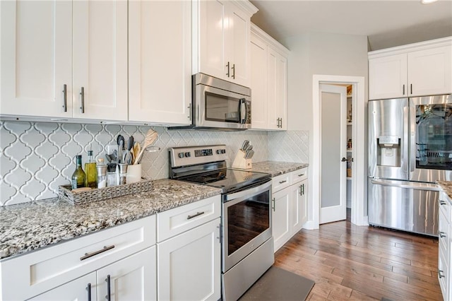 12435 Parkview Ave, Kansas City, KS 66109 - kitchen featuring appliances with stainless steel finishes, white cabinets, backsplash, and light stone countertops