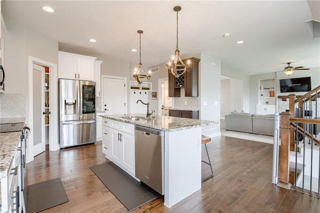 12435 Parkview Ave, Kansas City, KS 66109 - kitchen featuring stainless steel appliances, a sink, backsplash, a chandelier, and recessed lighting