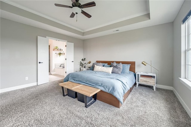 12435 Parkview Ave, Kansas City, KS 66109 - carpeted bedroom with a tray ceiling, baseboards, ornamental molding, ensuite bath, and a ceiling fan