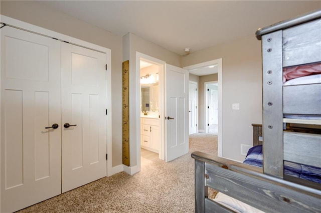 12435 Parkview Ave, Kansas City, KS 66109 - bedroom with light carpet, a closet, baseboards, and connected bathroom