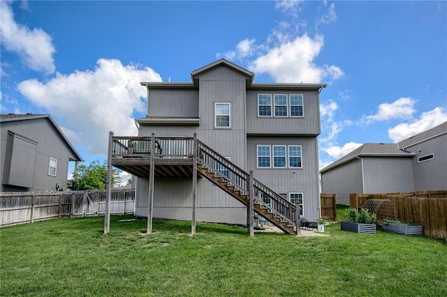 12435 Parkview Ave, Kansas City, KS 66109 - back of property featuring stairway, a deck, and a vegetable garden