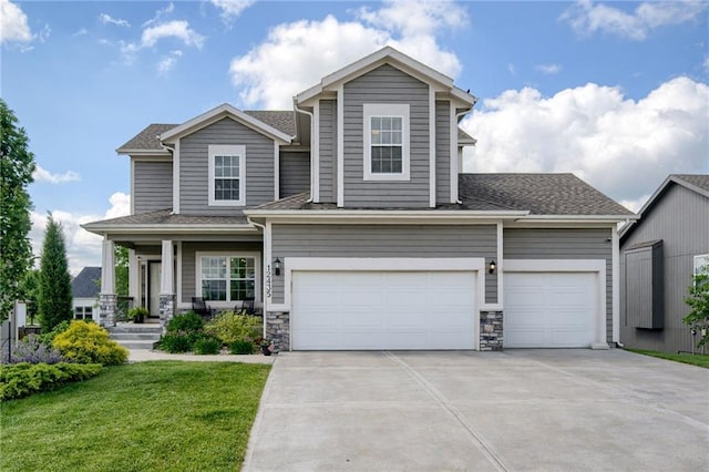 12435 Parkview Ave, Kansas City, KS 66109 - view of front of property with concrete driveway, covered porch, a front lawn, an attached garage, and a shingled roof