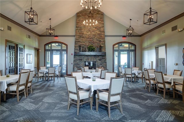 1014 Branchwood Ln, Raymore, MO 64083 - dining room with dark carpet, high vaulted ceiling, french doors, a chandelier, and healthy amount of natural light