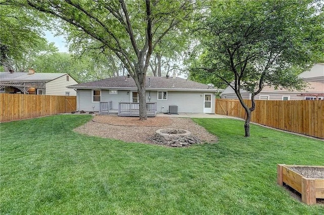 6109 W 54th Ter, Mission, KS 66202 - back of house featuring a wooden deck, central AC, and a fire pit