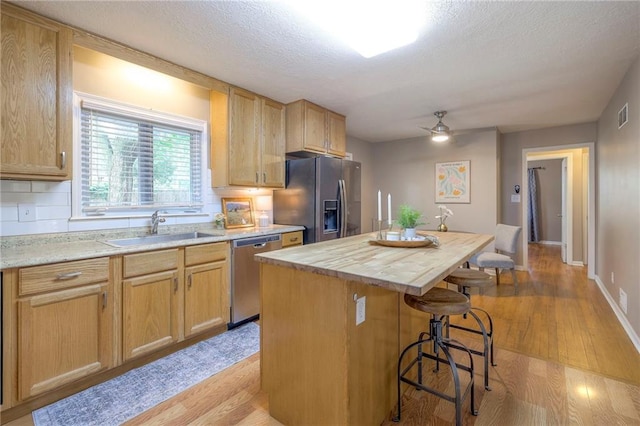 6109 W 54th Ter, Mission, KS 66202 - kitchen featuring stainless steel dishwasher, refrigerator with ice dispenser, a sink, a center island, and butcher block countertops