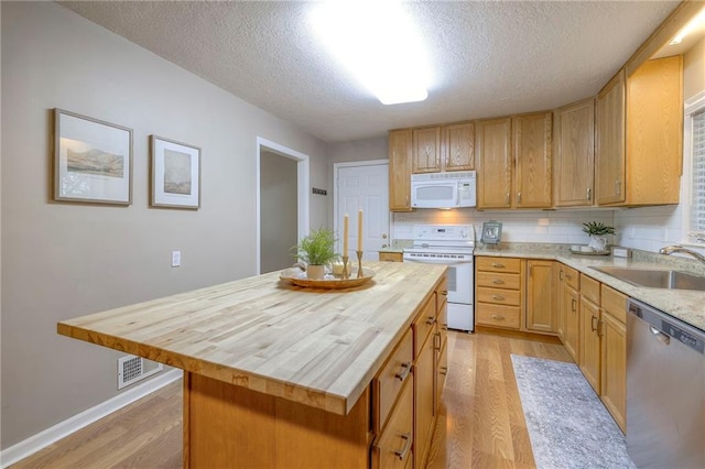 6109 W 54th Ter, Mission, KS 66202 - kitchen with white appliances, butcher block countertops, a sink, light wood-style flooring, and a textured ceiling