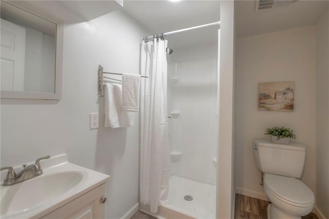 6109 W 54th Ter, Mission, KS 66202 - bathroom featuring toilet, vanity, a shower with shower curtain, baseboards, and wood finished floors