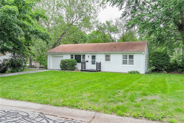 6721 Larsen Ln, Shawnee, KS 66203 - single story home with an attached garage, asphalt driveway, a front yard, and brick siding