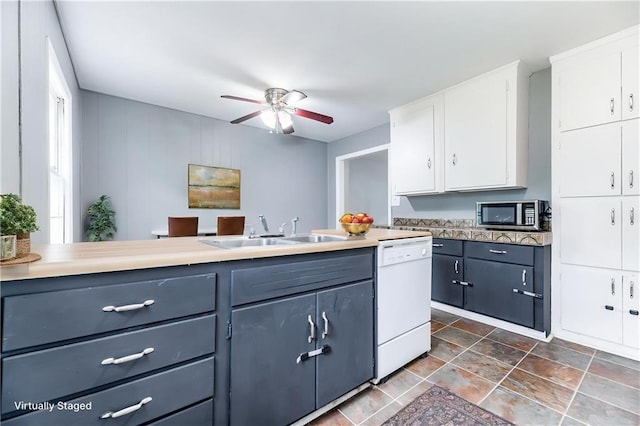 6721 Larsen Ln, Shawnee, KS 66203 - kitchen featuring dishwasher, a sink, stainless steel microwave, white cabinetry, and ceiling fan